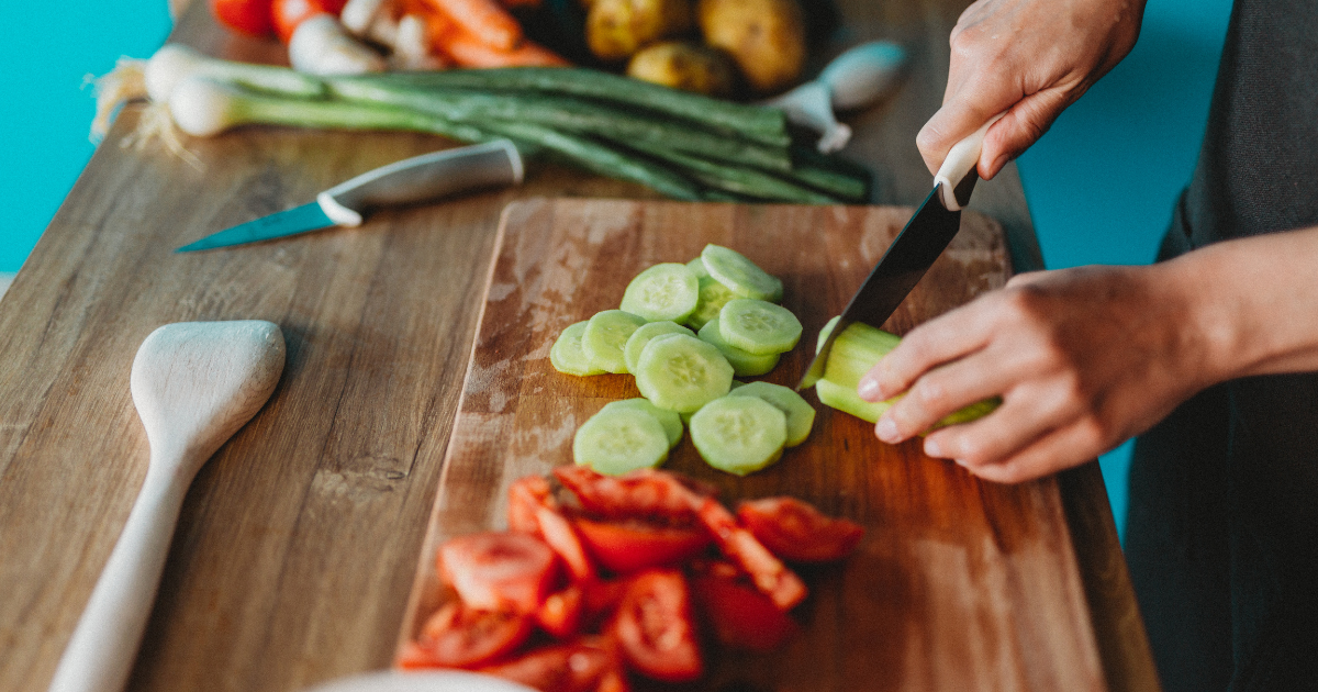 Person chopping cucumbers